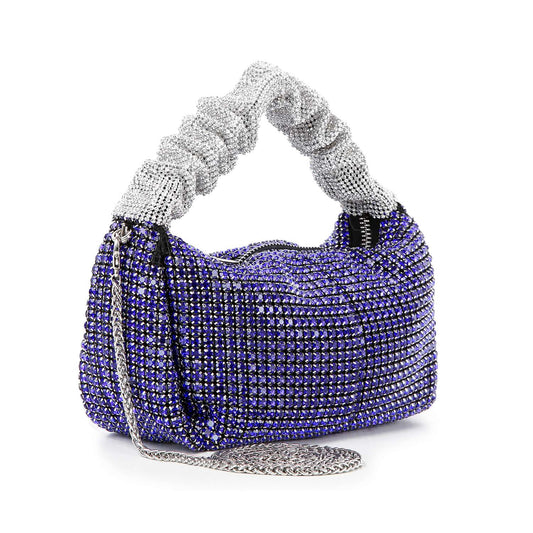 The Ruched Sparkling Stone Fashion Bag is a petite handbag with a silver knotted handle, blue and silver rhinestones, and a silver chain strap—perfect for adding sparkle to any outfit.