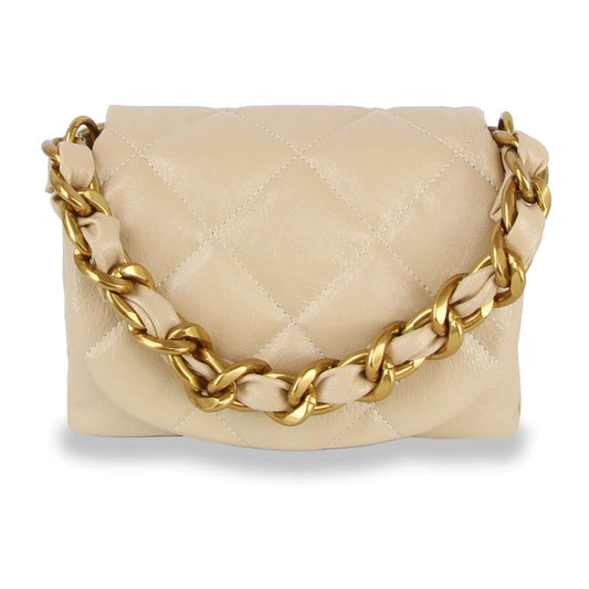 The Quilted Front Flap Shoulder Bag is a beige faux-leather hobo handbag featuring quilted detailing and a chunky gold chain strap draped across the front.