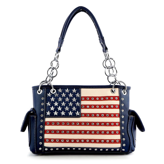 The American Flag Rhinestone Handbag features a blue faux leather design with silver studs, an American flag motif, two side pockets, and silver chain handles—blending patriotic style with everyday practicality.