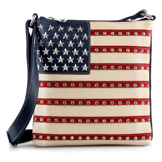The American Flag Rhinestone Crossbody Sling features a faux leather design with decorative studs, a blue field with silver stars, and patriotic flair—ideal for anyone seeking a standout, stylish everyday bag.