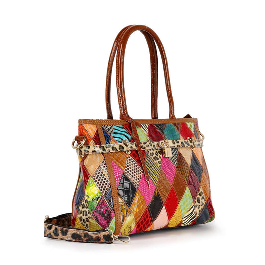 The Genuine Leather Colorful Belted Tote Handbag features double brown handles, gold-tone hardware, a vibrant patchwork of patterns and textures—including animal prints and faux leather—and a detachable leopard-print shoulder strap.