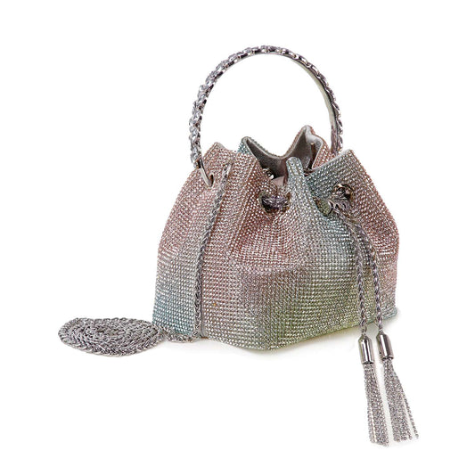 The Rhinestone Covered Petite Evening Bag features sparkling multicolored rhinestones, a braided handle, tassel drawstrings, and an attached matching circular pouch—all crafted from luxe faux leather.