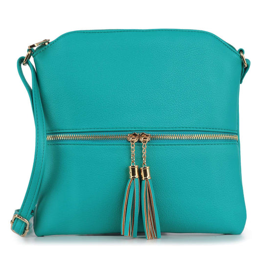 The Tassel Accented Crossbody Sling is a turquoise, lightweight bag with gold zipper, dual tassel accents, an adjustable strap, and a pebbled faux leather finish.