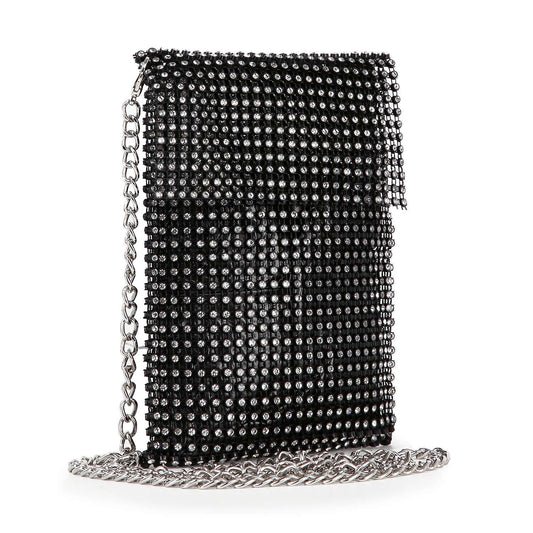 The Rhinestone Metal Mesh Cell Phone Crossbody is a small black bag with a flap closure, silver-tone hardware, sparkling rhinestones, and a long chain strap, displayed on the surface below it.