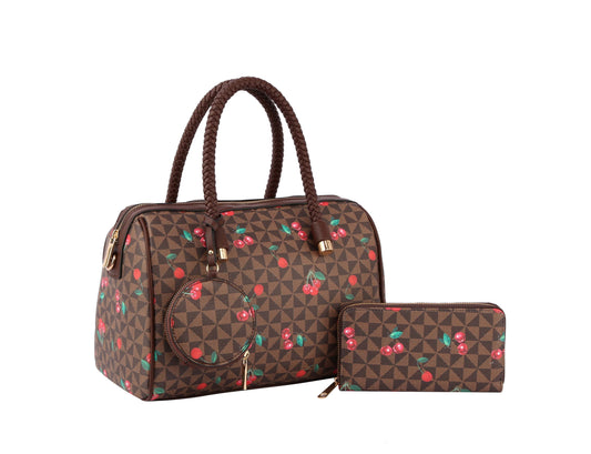 The Signature Cherry Print Satchel Set features a brown faux leather handbag with braided handles, a detachable strap, and a zip-around wallet—both adorned with geometric patterns and red cherry print, shown on a white background.