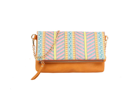 The Colorful Woven Crossbody Bag features a brown faux leather body, pastel geometric patterned flap, gold-toned hardware, chain strap, and zipper closure. Shown on a plain white background.