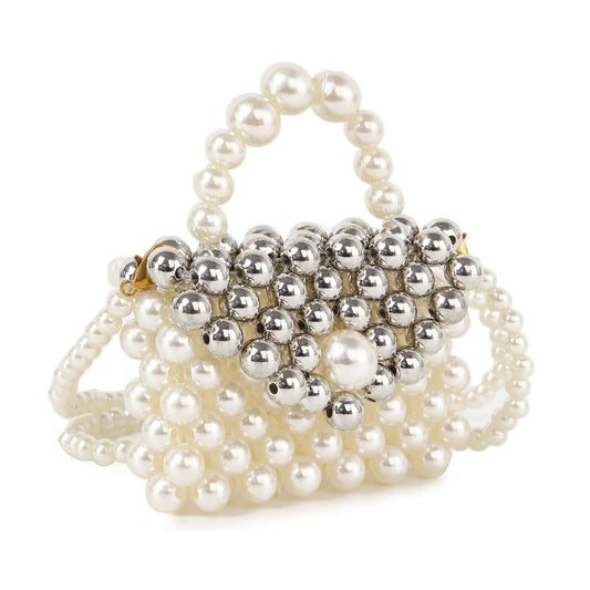 The Ultra Petite Pearl Evening Bag is a small white and silver beaded bag with a beaded top handle, shoulder strap, and a decorative large pearl accent on the front flap.