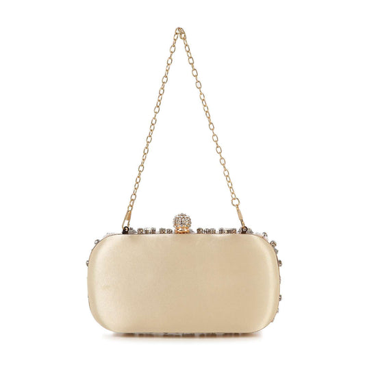 The Highly Decorative Retro Evening Bag is a small, rectangular gold clutch featuring a decorative clasp, delicate chain handle, and sparkling stones embellishing the top edge.