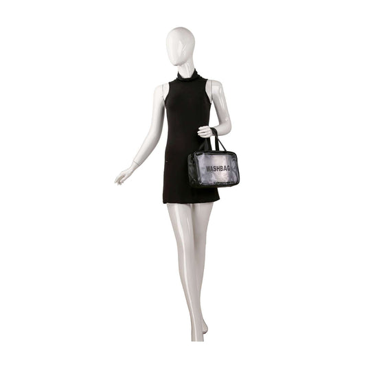 A mannequin in a sleeveless black dress holds a clear bag from the Set of Three Make Up Travel Bags, featuring a WASHBAG label and top zip closure, standing against a plain white background.