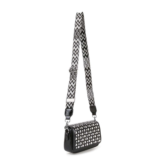 The Guitar Strap Accented Studded Shoulder Bag is a small black faux leather shoulder bag featuring silver studs on the front and a wide, adjustable black-and-white zigzag strap. Displayed against a plain white background.