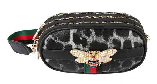 The Rhinestone Bee Leopard Print Crossbody Bag is a small black and gray faux leather bag with gold zippers, triple zip closure, green and red striped accents, a jeweled gold bee ornament, and an adjustable matching striped strap.