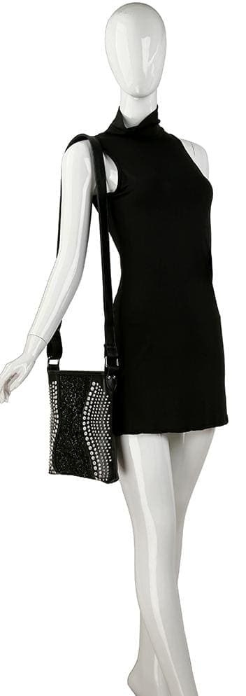 A mannequin in a sleeveless black dress carries the Brilliant Rhinestone and Lace Crossbody Sling on its right shoulder. The bag features white dotted wave patterns and is shown against a white background.