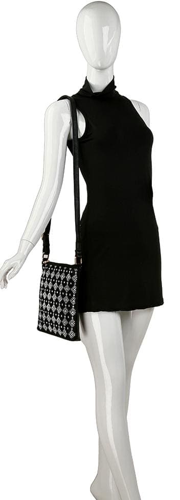 A mannequin in a sleeveless black mini dress carries the Diamond Stone Pattern Crossbody Sling, featuring a black and white pattern and an adjustable strap.