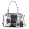 The Two Piece Fashion Handbag Set includes a shiny silver faux leather bag with double handles and a matching clutch, both accented with central vertical black rhinestone strips—perfect as an elegant rhinestone shoulder bag.