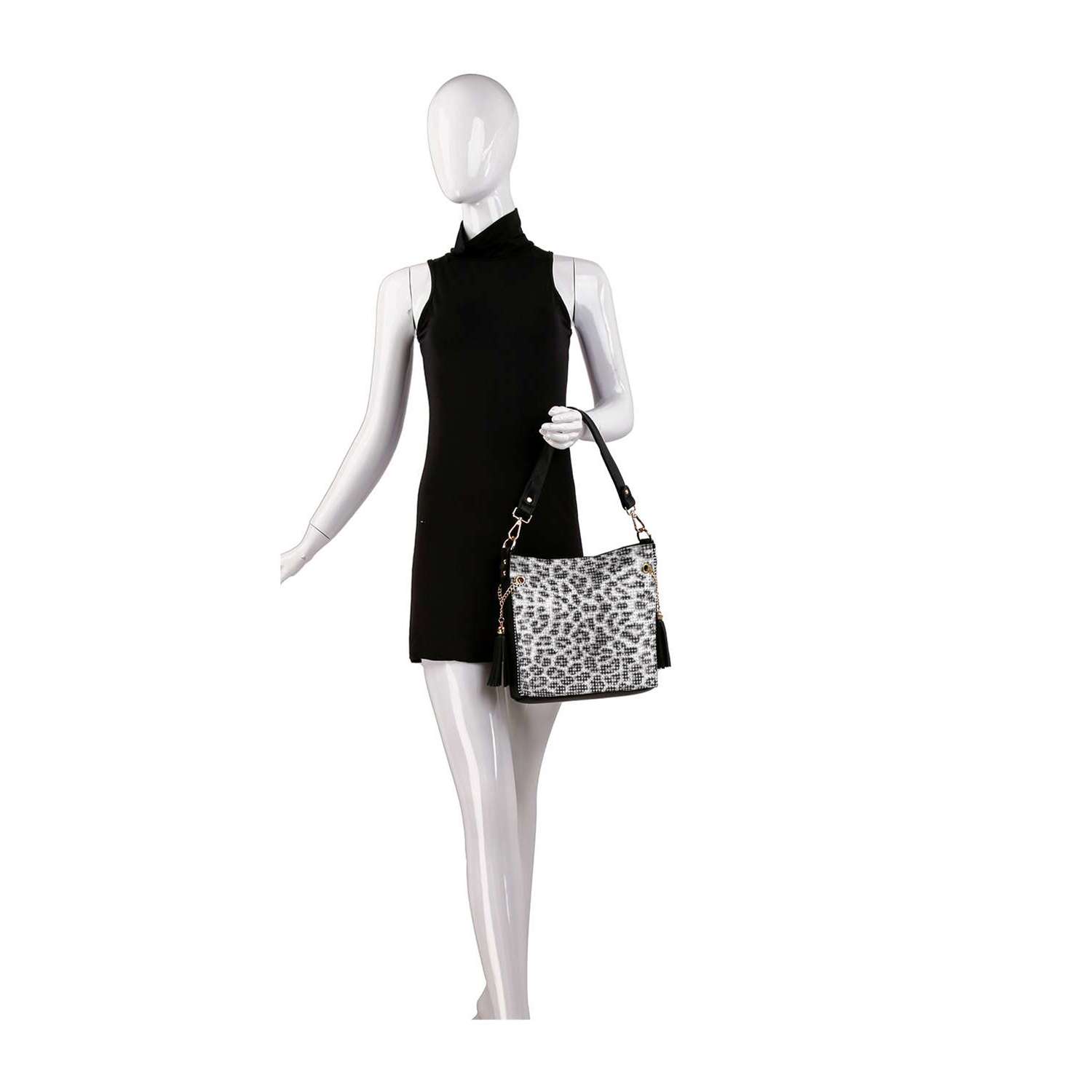 A mannequin in a sleeveless black dress holds the Super Sparkling Crossbody Sling, a white and gray leopard print faux leather bag with black straps, standing against a plain white background.