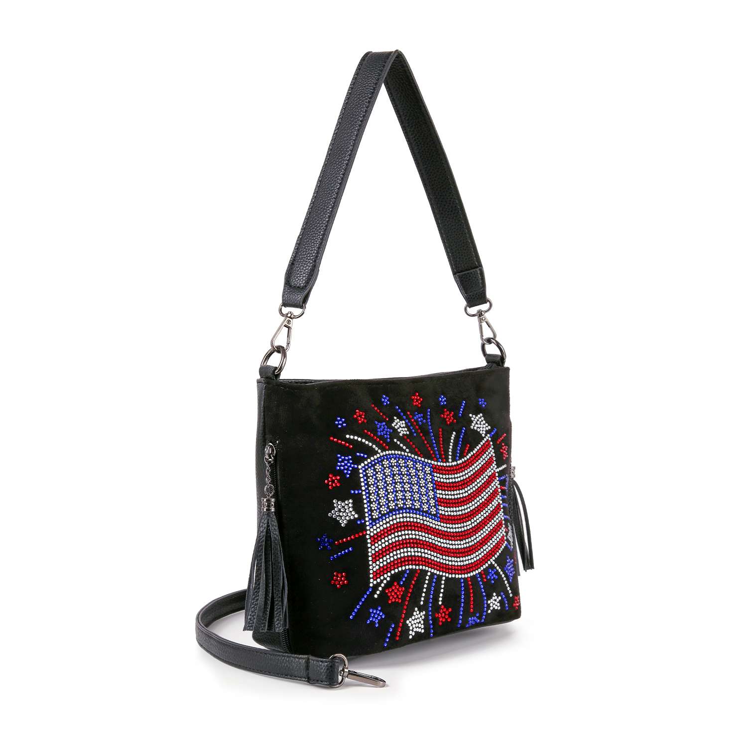 The Americana Flag Burst Hobo Crossbody is a black faux leather bag with a beaded American flag and fireworks design, featuring a tassel zipper pull and detachable crossbody strap.