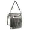 The Classic Fringe Convertible Crossbody is a gray faux leather bag featuring silver studs, long front fringe, a zippered front pocket, and a detachable shoulder strap.