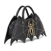The Bat Wing Rhinestone Spider Accent Fashion Bag is a black faux leather tote shaped like a spider web, with white stitching and a large gold jeweled spider embellishment on the front.