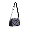 The Ultra Petite Sparkling Shoulder Bag features a black design with a wide faux leather strap, silver chain detail, and a front flap adorned with silver and blue rhinestones in a chevron pattern.