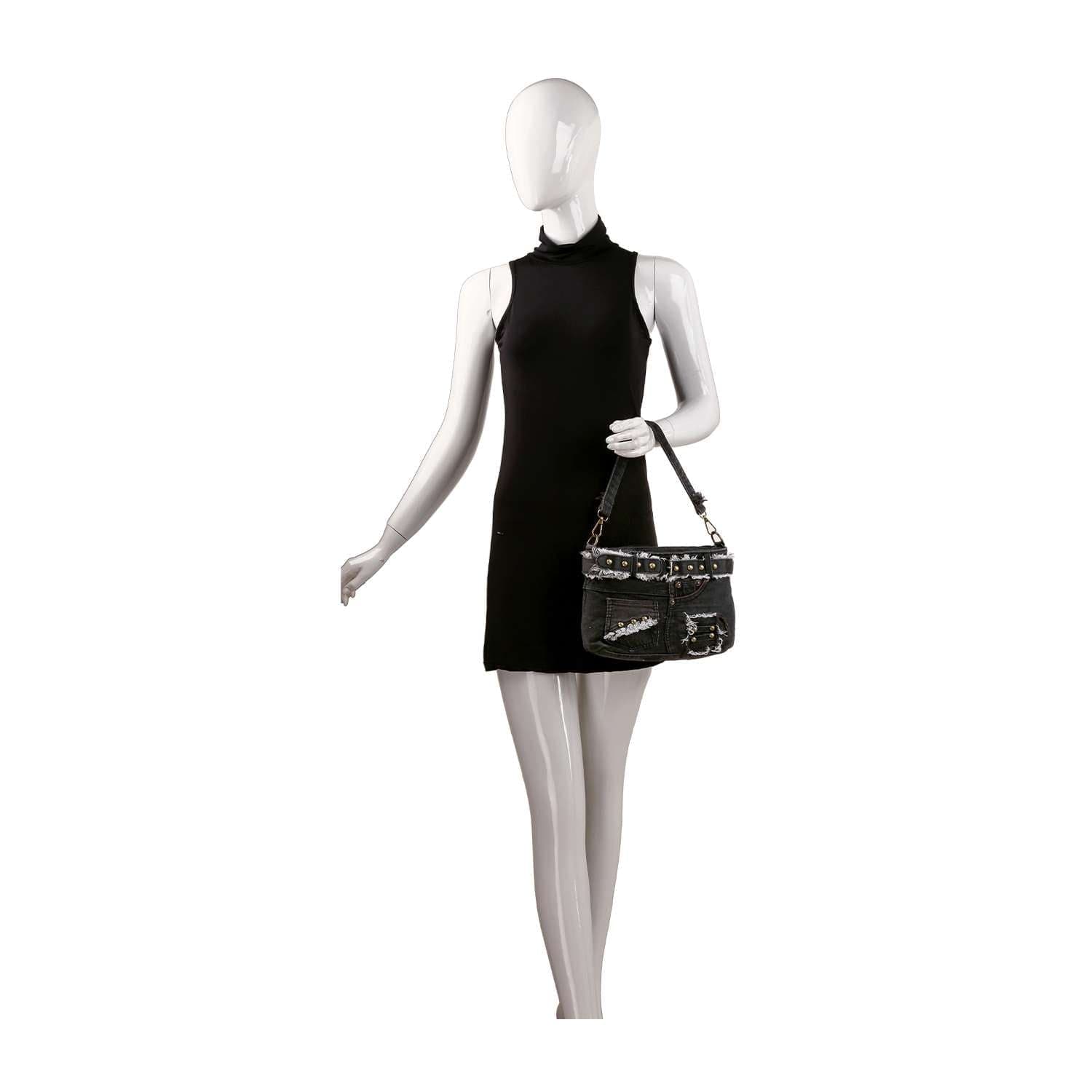 A white mannequin in a sleeveless black mini dress holds a Belted Denim Hobo Handbag, standing against a plain white background.