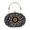 The Highly Decorative Retro Evening Bag is a black oval evening bag embellished with sparkling black and silver beads, featuring a retro pattern, ornate gold floral handle, and a decorative gemstone clasp on top.