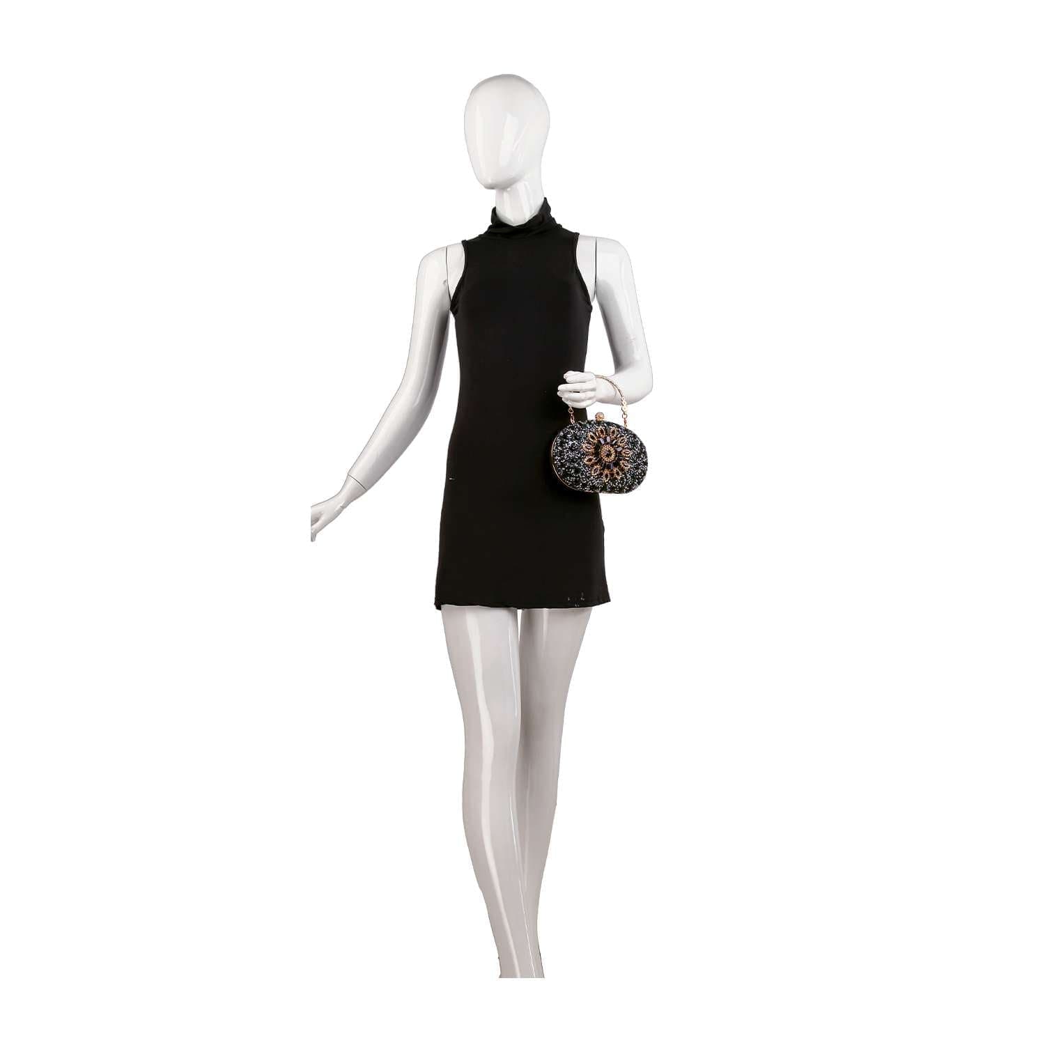A white mannequin in a sleeveless, high-neck black mini dress holds the Highly Decorative Retro Evening Bag—a small, round patterned evening bag with a chain handle—in its right hand against a plain white background.