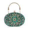 The Highly Decorative Retro Evening Bag is an oval-shaped evening purse adorned with green and clear gemstones in a floral retro design, featuring a jeweled clasp and a gold chain handle.