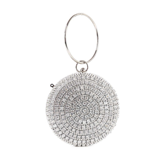The Circular Rhinestone Evening Bag is a round, silver evening bag adorned with sparkling rhinestones in a circular pattern and a large metal ring handle—perfect as a dazzling wristlet for any night out.