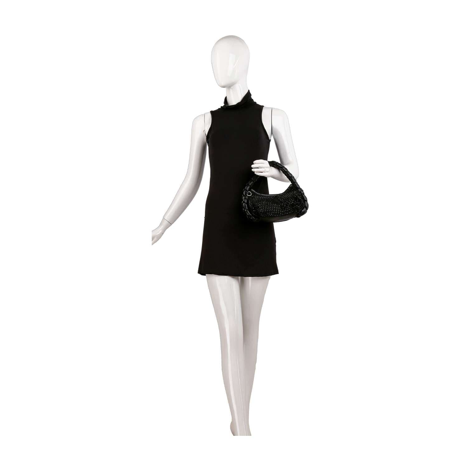 A mannequin in a sleeveless, high-neck black mini dress holds the Petite Decorative Trim Shoulder Bag with silver-toned hardware on its left arm, posed against a plain white background.