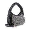 The Petite Decorative Trim Shoulder Bag is a black faux leather handbag with a thick braided handle, shiny silver studs on the front panel in neat rows, and finished with elegant silver-toned hardware.