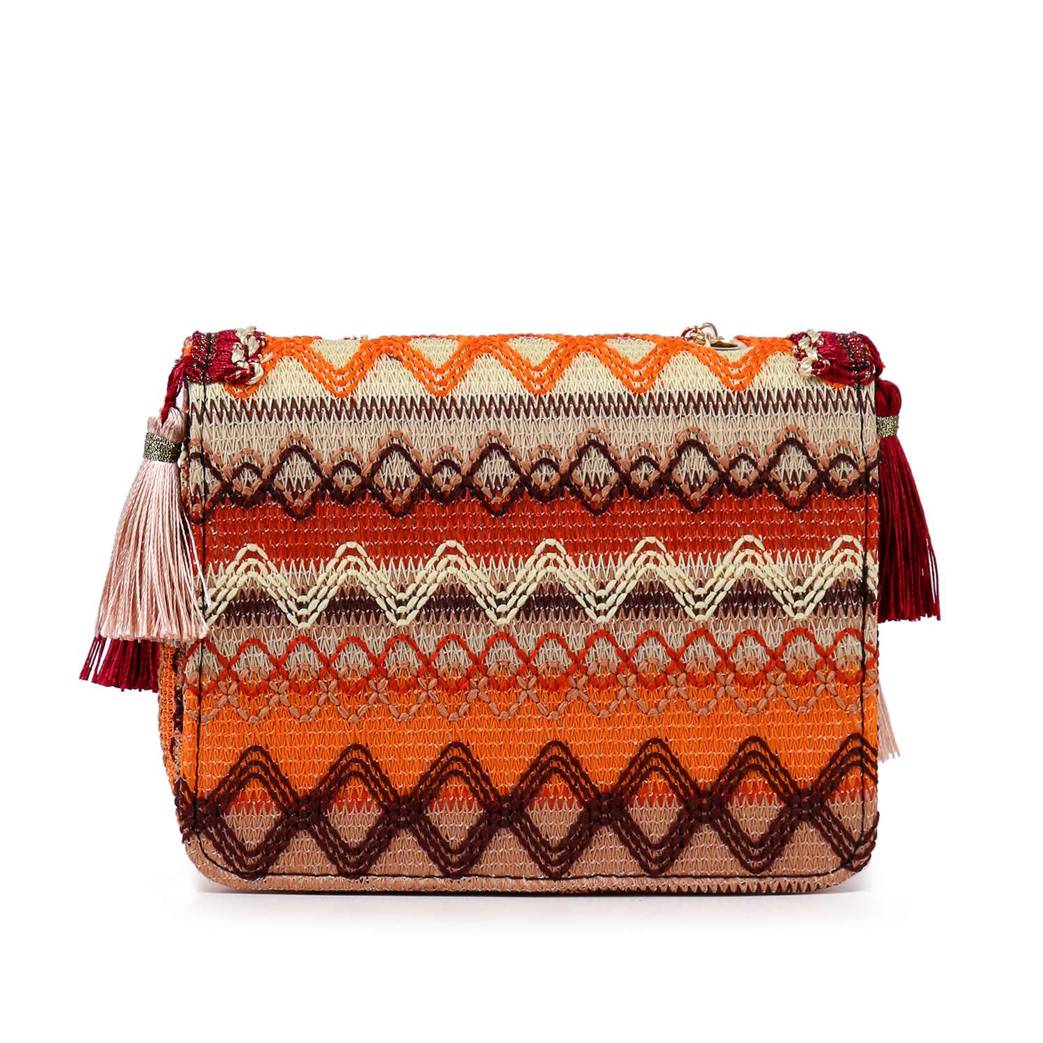 The Tassel Accented Woven Design Shoulder Bag features colorful zigzag and diamond patterns in orange, red, and beige, with tasseled accents on each side for a boho-inspired style.