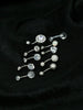 The Set of 10 Dazzling Belly Button Rings in 8mm sizes is displayed on black fabric, featuring crystal, glitter, and opal-like designs—perfect styles for everyday wear.