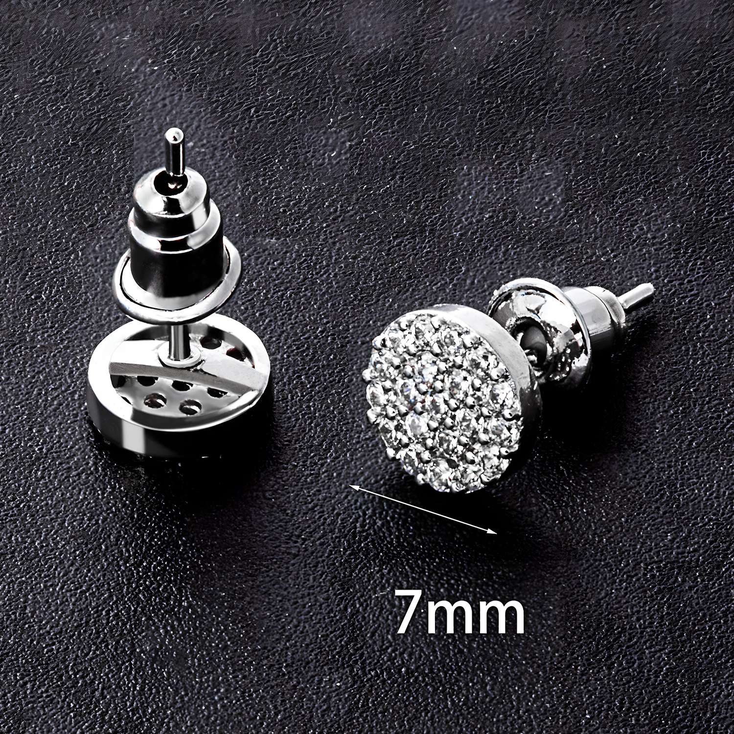 Two Fashion Rhinestone Earrings with round, crystal-encrusted fronts are displayed on a black textured surface. One rhinestone stud stands upright while the other lies flat, showing its 7mm diameter.