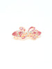 The Rhinestone Design Hair Clip is a stylish gold bow-shaped accessory, embellished with pink and clear rhinestones, shown against a simple white background.