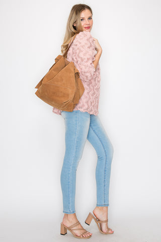 A woman stands against a white background, wearing a pink textured sweater, light blue skinny jeans, beige heeled sandals, and carrying the Genuine Leather Two-In-One Hobo Handbag Set over her shoulder.