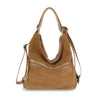 The Genuine Leather Convertible Hobo Backpack in tan suede and leather features silver zippers, a shoulder strap, and two handles, shown standing upright against a white background.