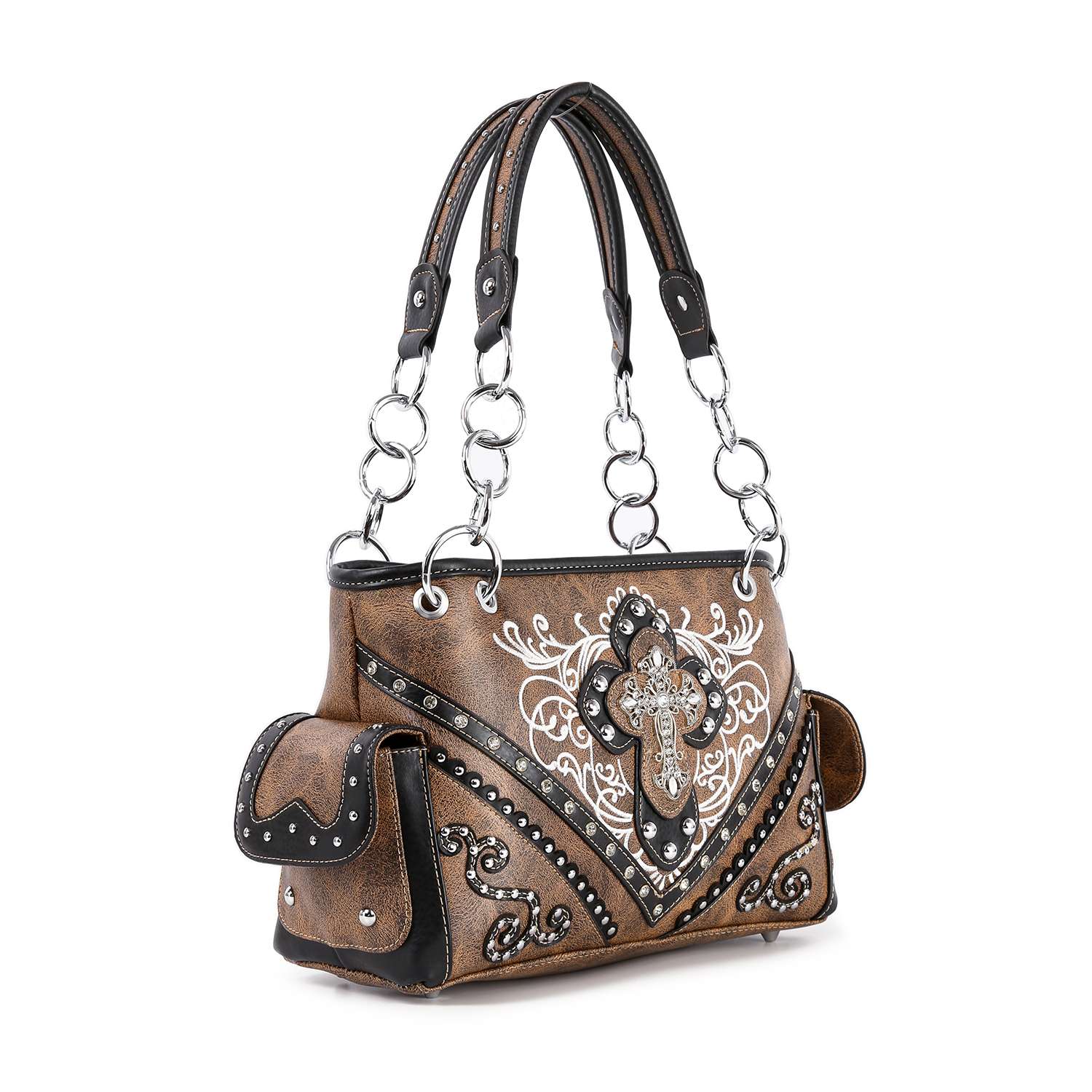 The Western Rhinestone Cross Handbag is a brown and black faux leather concealed carry purse with metal ring handles, white embroidery, stud accents, a large ornate cross, side pockets, and stylish western-inspired details.
