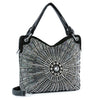 The Unique Rhinestone Design Handbag is a black bag with a symmetrical starburst pattern in silver and clear rhinestones, two handles, a detachable shoulder strap, and enough space to fit a tablet.