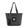 The Patterned Bling Layered Design Shopper Tote is a black faux leather tote with dual handles, white and silver studded circular designs, a central floral motif, a black tassel accent, and tablet compatibility for stylish functionality.