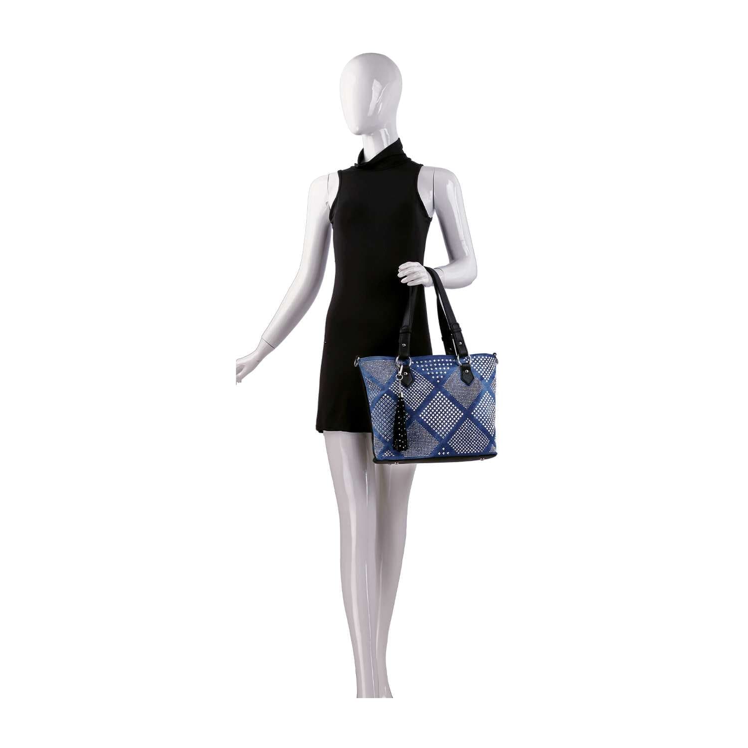 A mannequin in a sleeveless black dress holds the Diamond Pattern Shopper Style Tote with blue designs and black handles on its right arm, set against a plain white background.