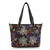 The Colorful Rhinestone Patterned Tote Handbag is a black faux leather bag with two handles, embellished with red, blue, white, and gold rhinestones in bold floral and leaf patterns covering the entire surface.
