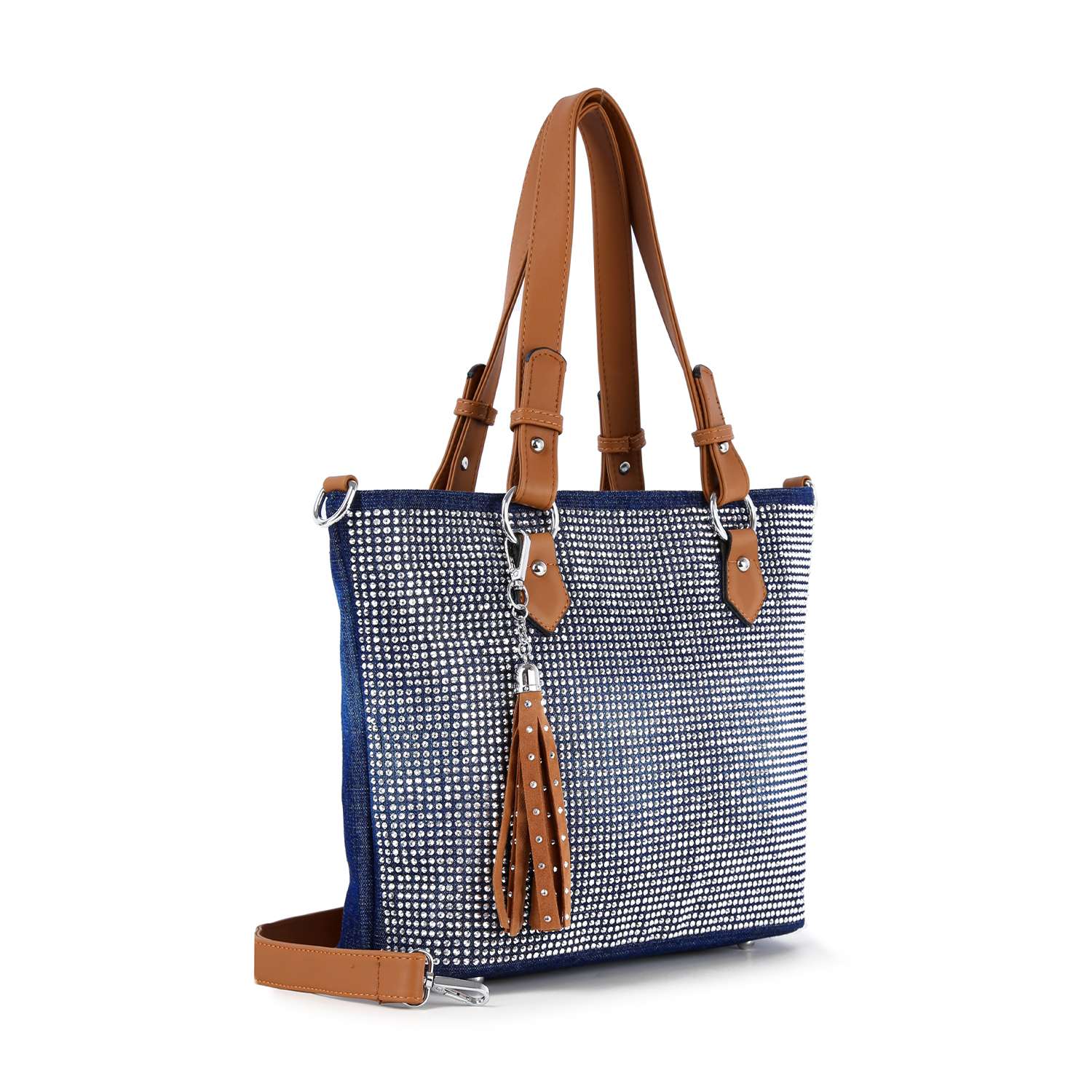 The Rhinestone Denim Fashion Tote features brown leather handles and strap, a blue and white dotted pattern, and a matching tassel accessory hanging from one handle for added style.
