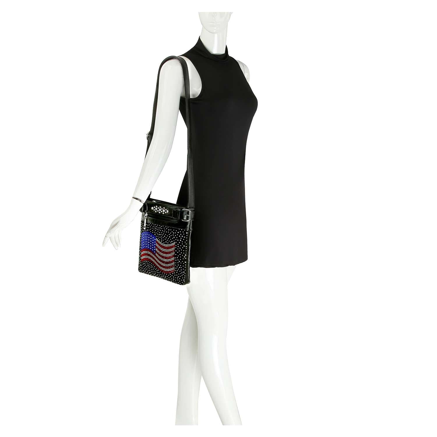 A mannequin in a sleeveless black mini dress displays the Rhinestone American Flag Crossbody Sling, featuring a beaded flag design. This patriotic handbag stands out against the white background.