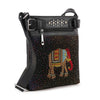 The Rhinestone Bling Elephant Crossbody Sling is a black faux leather bag with a colorful dotted and rhinestone elephant design, silver studs on the front flap, a zipper pocket, and an adjustable shoulder strap.
