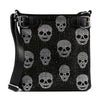 The Rhinestone Skull Pattern Crossbody Sling is a black faux leather bag with multiple silver rhinestone skull designs, two black buckle straps at the top, and a sleek black shoulder strap.