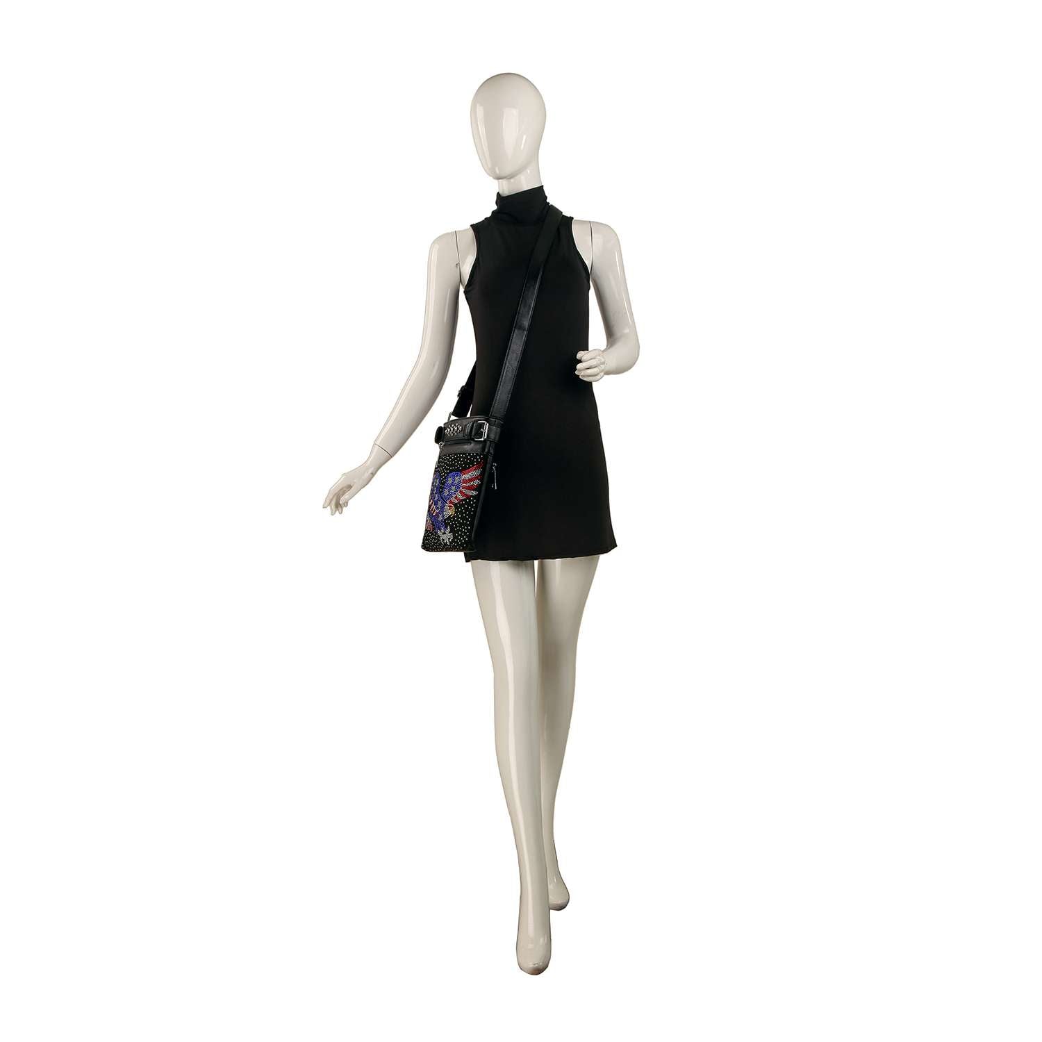 A mannequin in a sleeveless black mini dress carries the Patriotic Eagle Bling Crossbody Bag, featuring a colorful design, posed as if walking against a white background.
