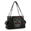 The Sugar Skull Fashion Handbag is a black faux leather shoulder bag featuring silver studs, side pockets, two handles, and a bold front sugar skull design made of vibrant red, blue, and white rhinestones.