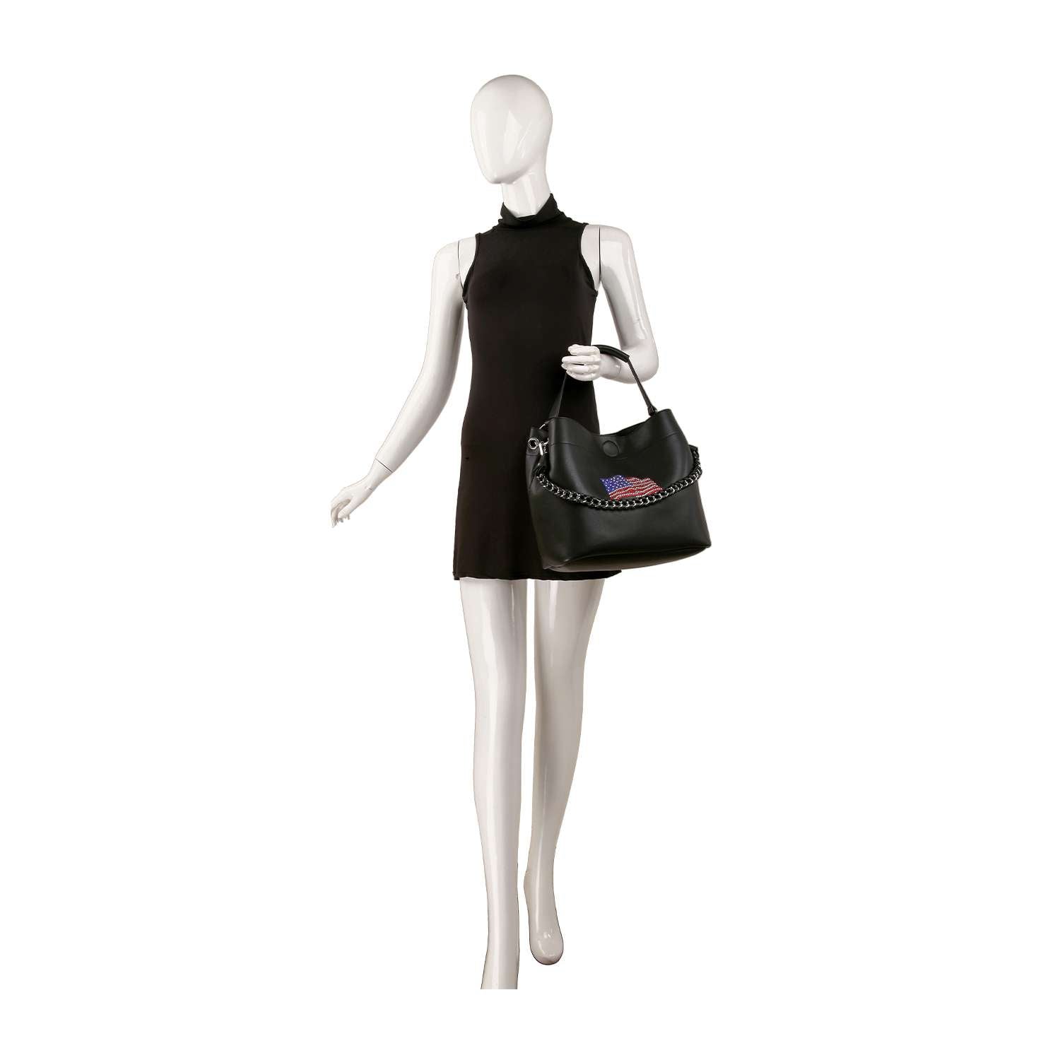 A white mannequin in a sleeveless black mini dress holds the Flag Design Sparkling Rhinestone Handbag Set with chain details and a colorful patch, posed against a plain white background.
