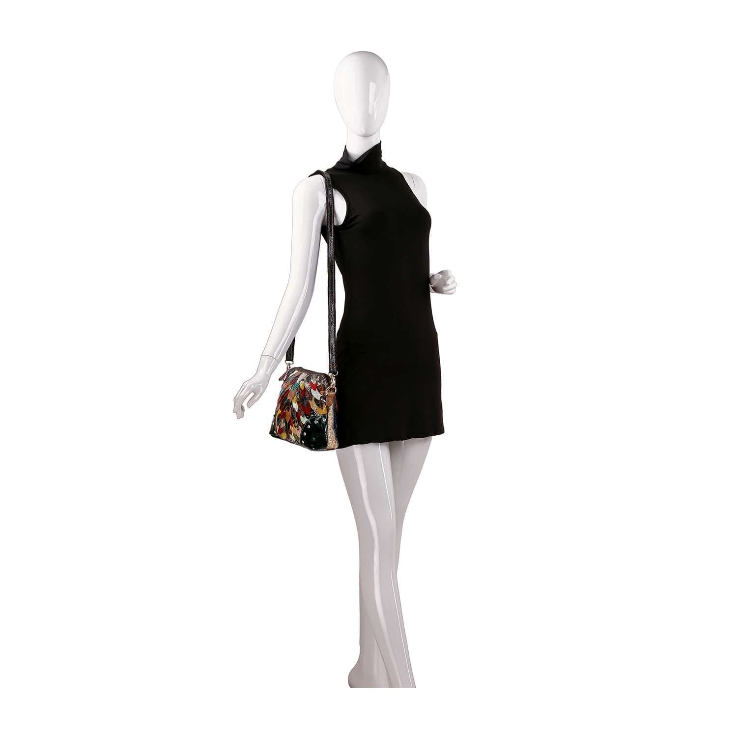 A white mannequin wears a sleeveless black mini dress and holds the Genuine Leather Colorful Petal Crossbody Sling with gold-toned hardware on its shoulder, posed against a plain white background.