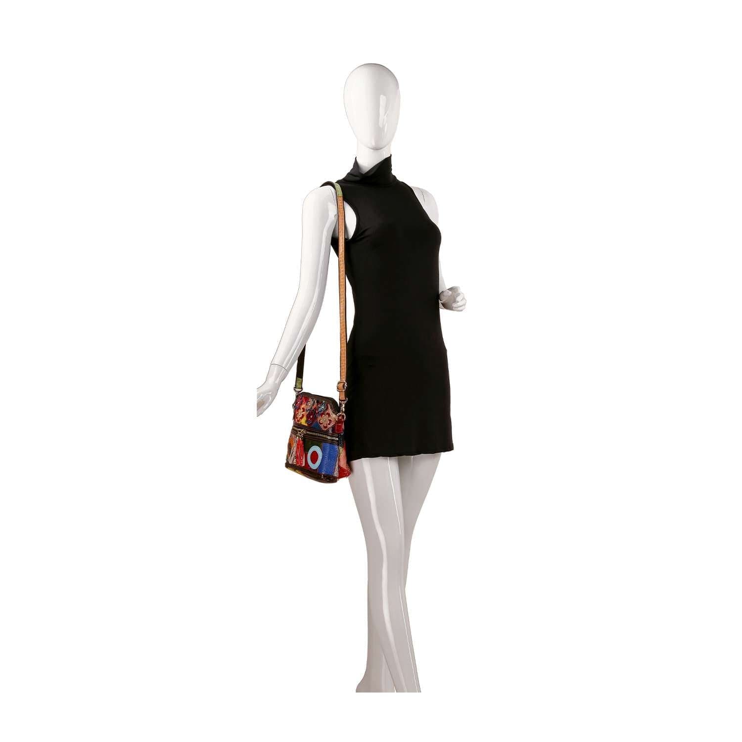 A mannequin wearing a sleeveless black mini dress and carrying the Genuine Leather Colorful Crossbody Sling, featuring colorful embroidery and a patterned, adjustable strap.